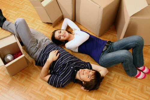 Professional movers handling furniture during house removals in Cambridgeheath